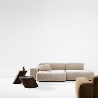 Beige plush sofa with smooth texture, complemented by dark brown angular side tables. Modern, minimalistic design.