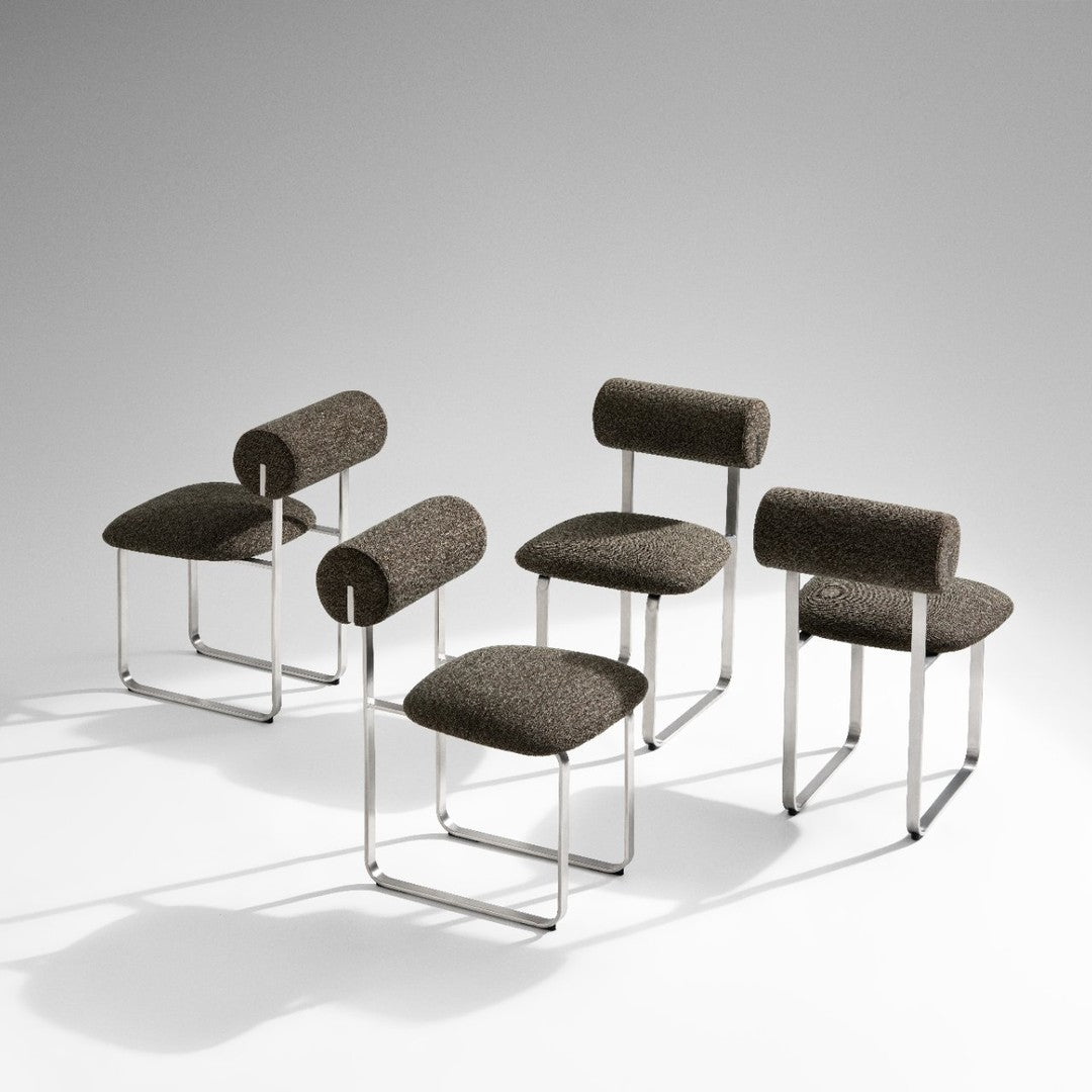 Brown patterned chairs with chrome legs, featuring unique cylindrical backrests. Modern design for stylish seating.