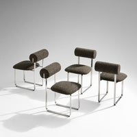Brown patterned chairs with chrome legs, featuring unique cylindrical backrests. Modern design for stylish seating.