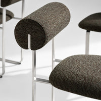 Brown textured upholstery with subtle grey and beige flecks on modern chair design.