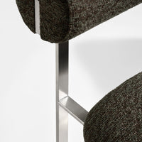 Textured brown fabric with subtle gray and green tones on a modern chair design.