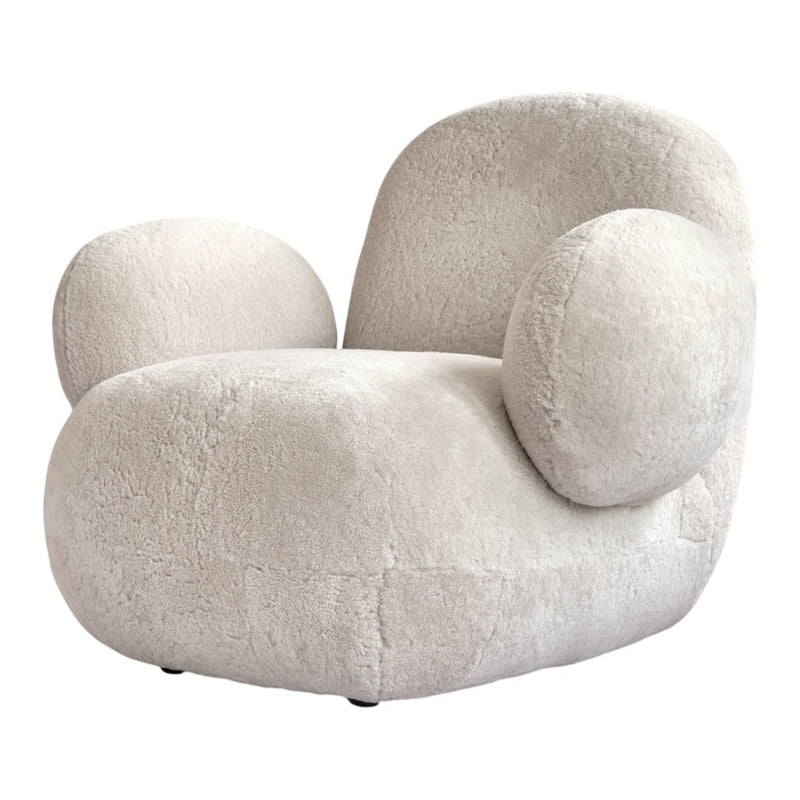 Cream-colored plush armchair with rounded shapes and soft texture, perfect for modern decor.
