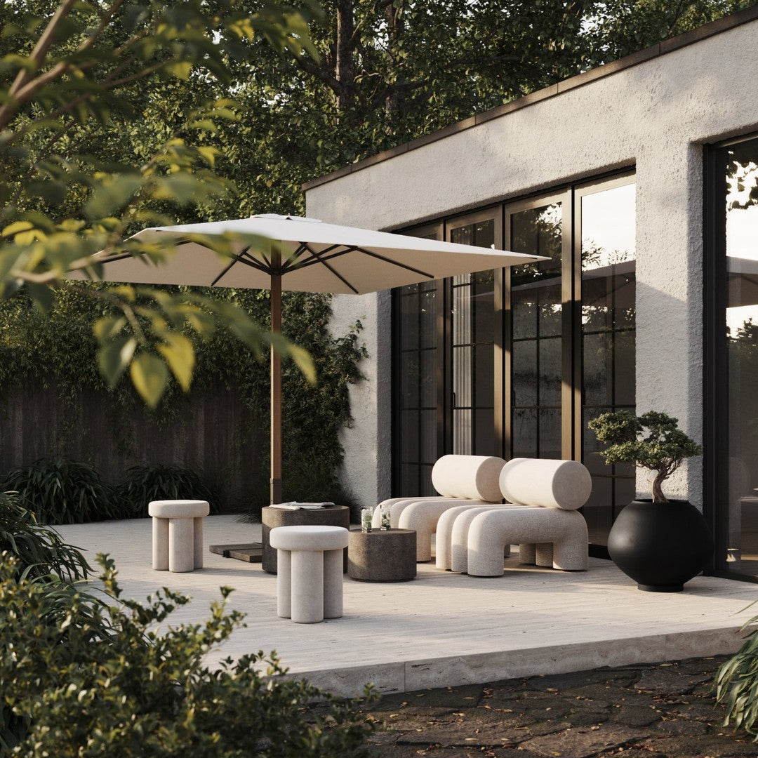 Modern outdoor patio set featuring beige and gray tones with minimalistic round patterns against a lush green backdrop.