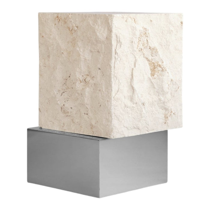 White textured stone cube atop a sleek silver metal base, adding a modern touch to decor.
