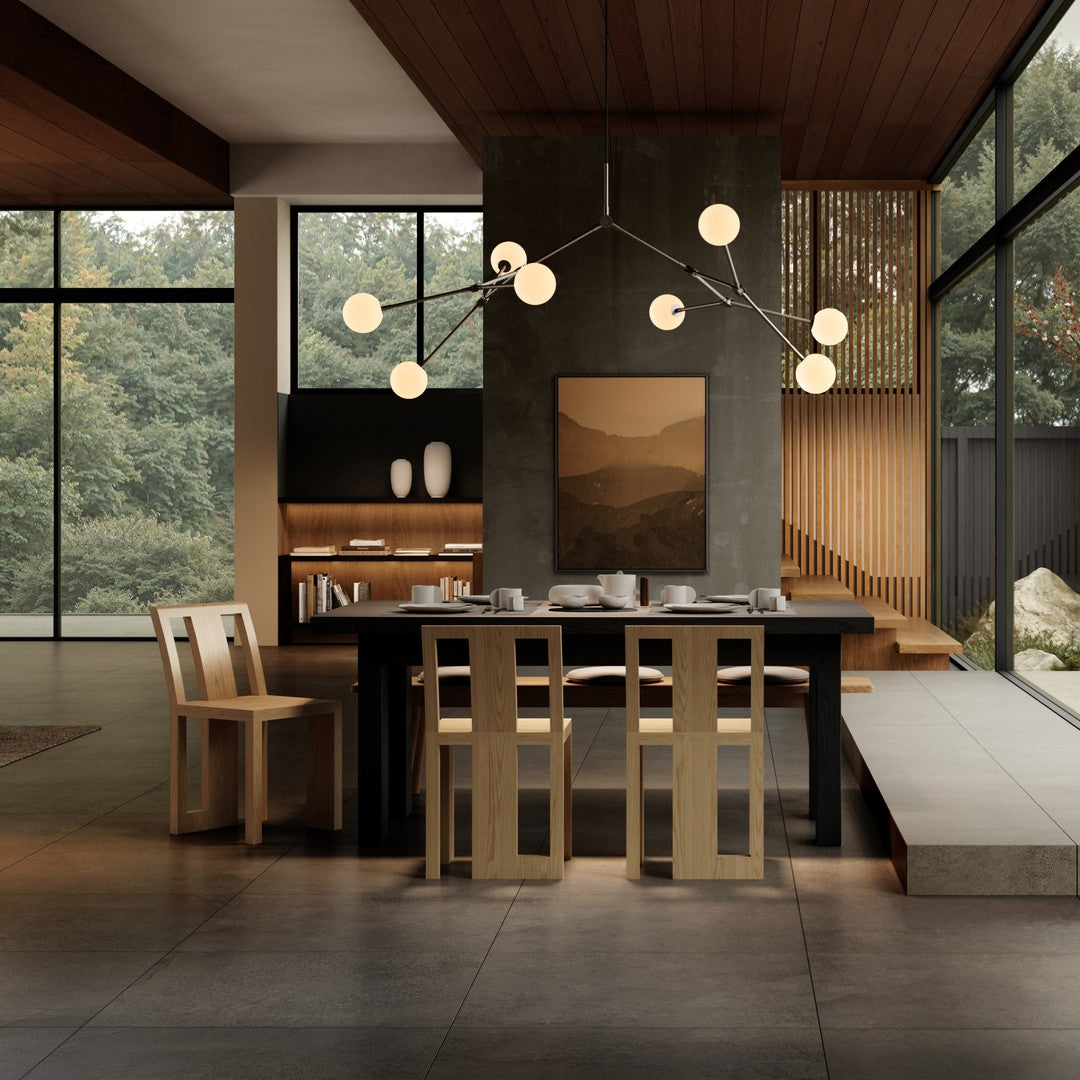 Modern dining room featuring neutral tones, warm wood textures, and a sleek black table with minimalist decor.