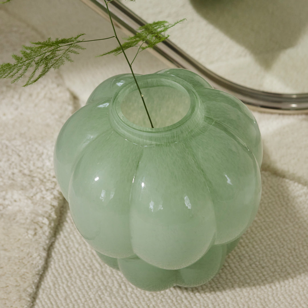 Mint green glass vase with a rounded, textured design, perfect for adding a touch of elegance to your decor.