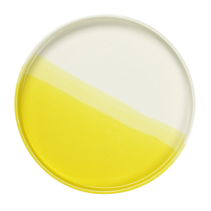 Round plate with a modern design featuring a white and vibrant yellow half-and-half pattern.