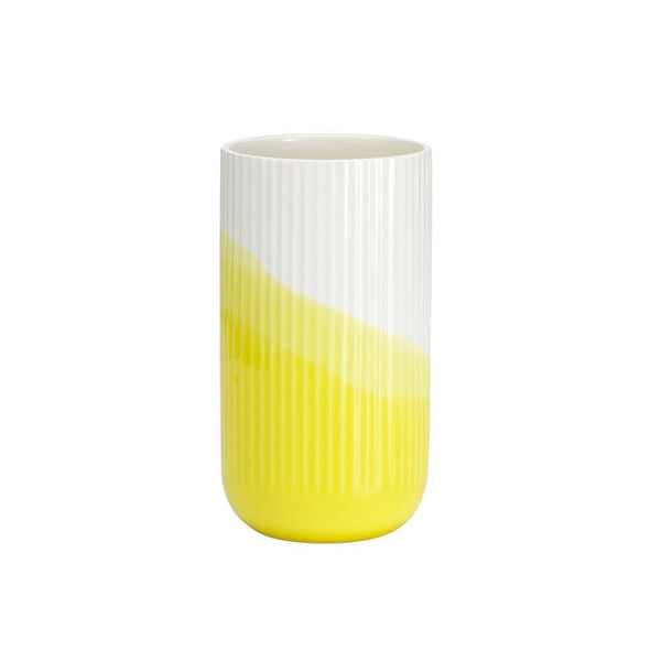 Yellow and white striped ceramic vase with a gradient design. Bright, modern color scheme for home decor.