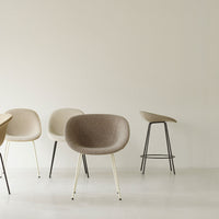 Minimalist chairs in soft beige and taupe tones with sleek metal legs, set against a neutral background.