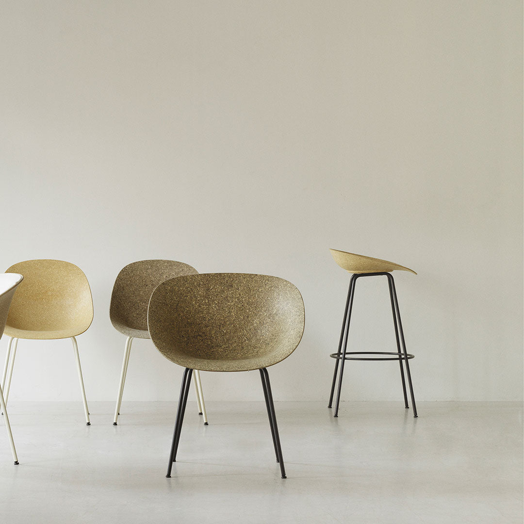 Set of modern chairs in soft beige and warm brown tones, featuring smooth curves and minimalist black metal legs.