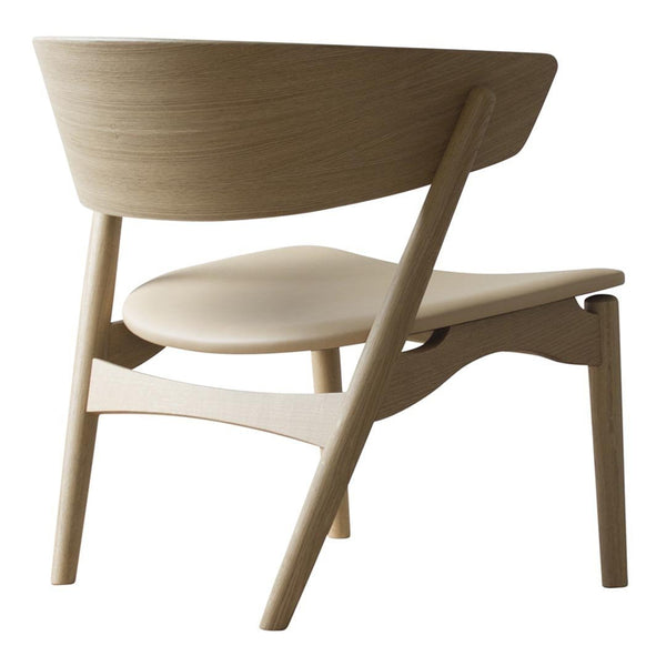 Modern light wood chair with a sleek, minimalist design and smooth, curved patterns. Perfect for contemporary decor.