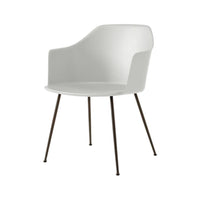 Modern white armchair with sleek lines and dark metal legs, perfect for contemporary decor.