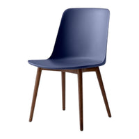 Navy blue chair with a minimalist design and wooden legs, showcasing a sleek, modern aesthetic.
