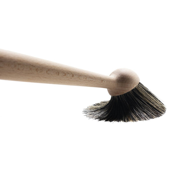 Natural wood handle with a dark bristle pattern, ideal for a stylish and functional cleaning tool.