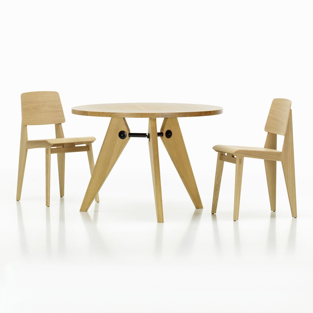 Light oak dining table set with minimalist design, featuring smooth wooden surfaces and clean lines.