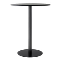 Sleek black round table with a smooth finish and minimalist design, perfect for modern spaces.
