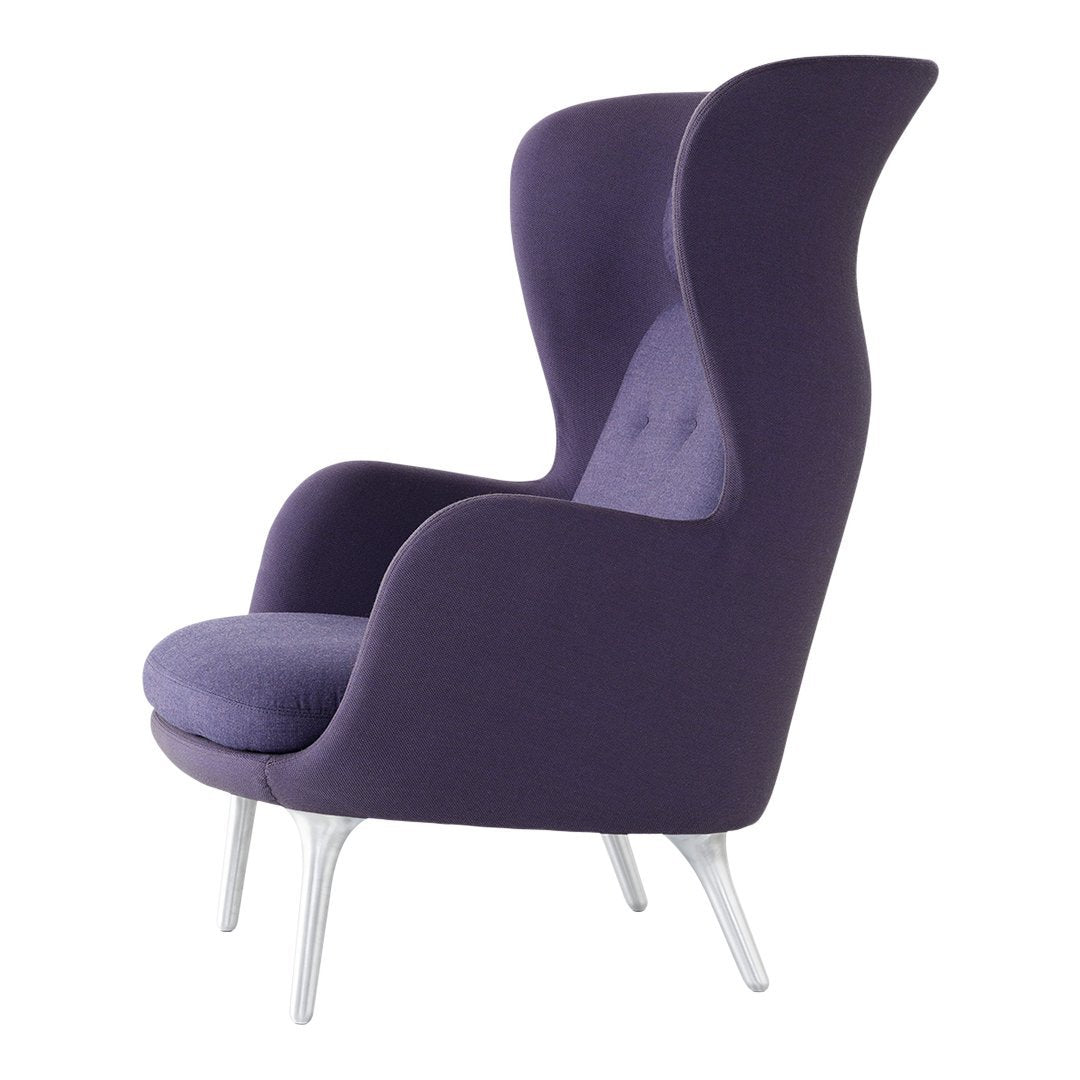 Purple upholstered armchair with high wings and a smooth fabric finish, complemented by sleek silver legs.