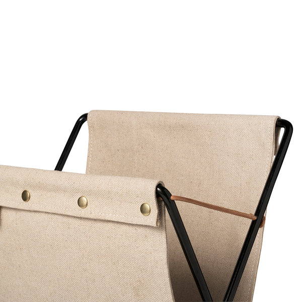 Beige canvas with brass buttons and a sleek black frame, showcasing minimalistic and modern design details.