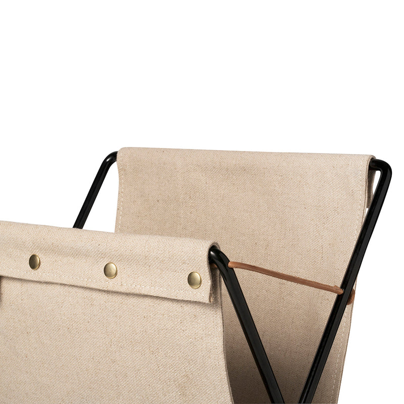 Beige canvas with brass buttons and a sleek black frame, showcasing minimalistic and modern design details.