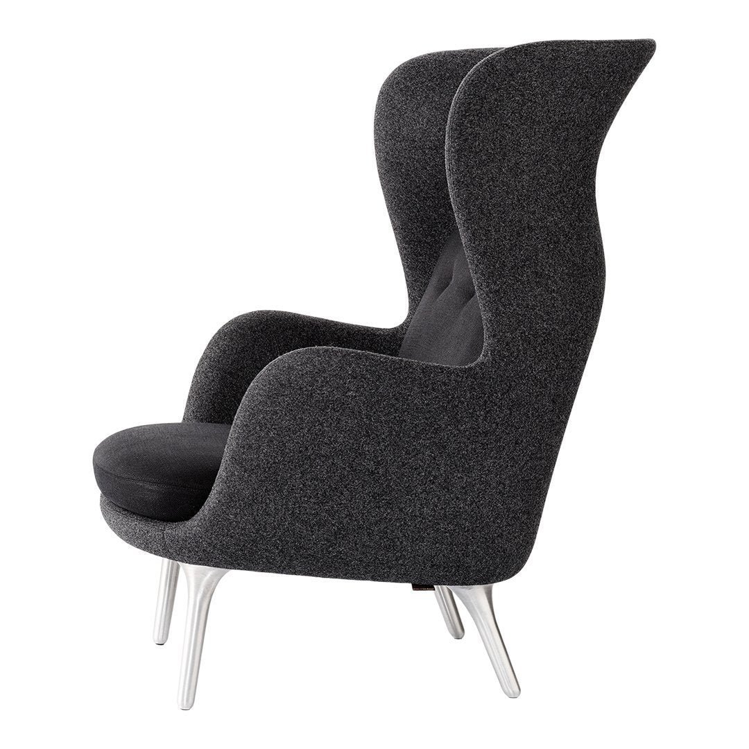 Sleek black armchair with a textured dark gray upholstery and elegant silver legs. Modern and stylish design.
