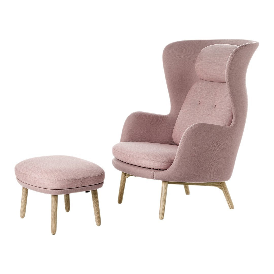 Pink upholstered armchair with matching ottoman, featuring a smooth fabric and simple wooden legs. Ideal for modern decor.