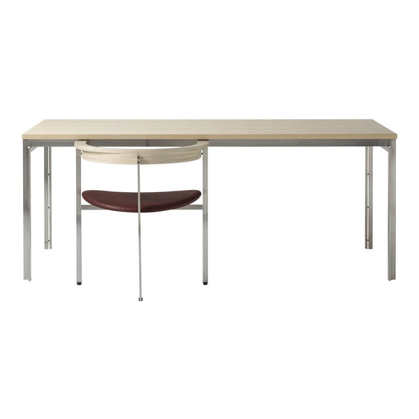 Minimalist desk with a light wood finish and silver legs, paired with a cream and burgundy chair.