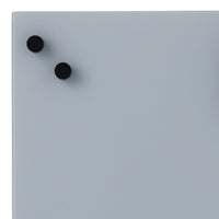 Light gray surface with two black round magnets, minimalistic design and smooth finish.