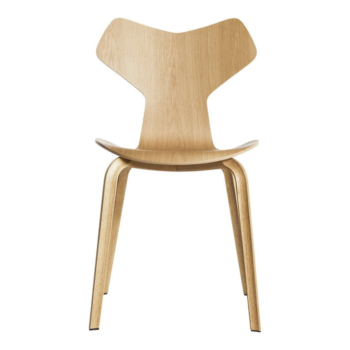 Light natural wood chair with a minimalist design and smooth finish, featuring a unique butterfly-shaped backrest.