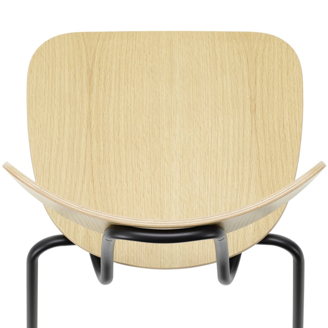 Natural wood grain chair with a smooth, minimalist design and black metal frame. Elegant light beige tones.