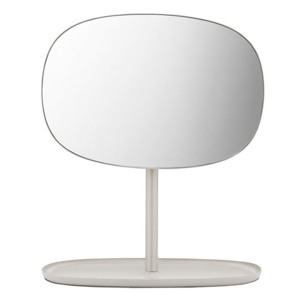 Minimalist oval mirror with a sleek white frame and base, featuring a smooth, reflective surface.