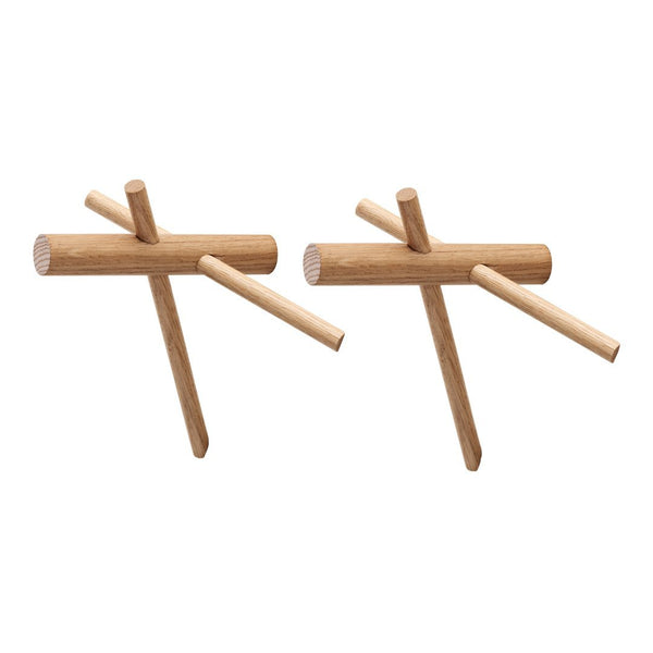 Light natural wood coat hooks with minimalist design and unique asymmetrical patterns. Perfect for modern interiors.