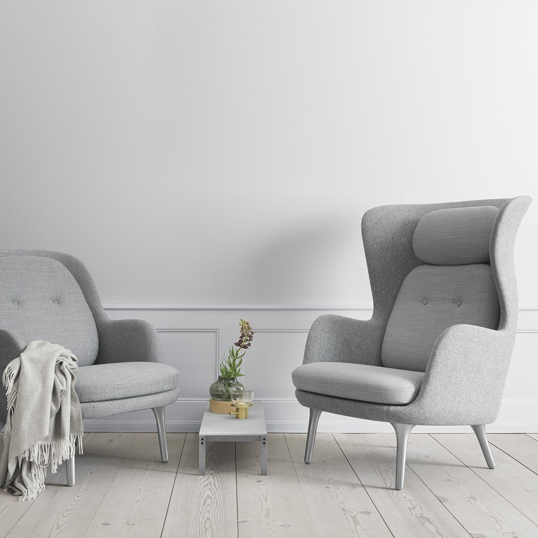 Gray upholstered chairs with smooth patterns, paired with a light wooden table and soft neutral tones in the background.