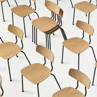 Light wood chairs with black metal legs, featuring a minimalist design, arranged in a dynamic pattern on a white background.