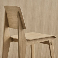 Light wood chair with a minimalist design, featuring a smooth, natural finish and subtle grain patterns.
