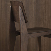 Modern dark wood chair with a sleek, minimalist design, featuring rich brown tones and smooth, clean lines.