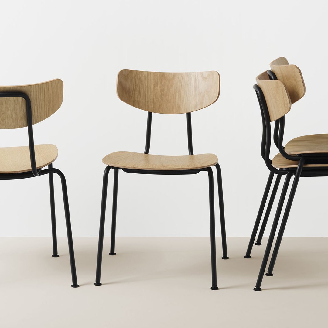 Natural wood finish chairs with black metal legs, featuring minimalist design and a modern aesthetic.
