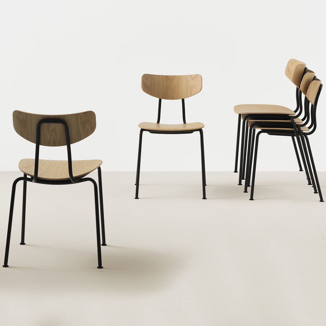 Five sleek wooden chairs with light oak seats and black metal frames against a minimalist white background.