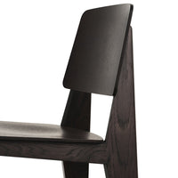 Black wooden chair with a minimalist design, featuring smooth finishes and geometric lines. Perfect for modern decor.