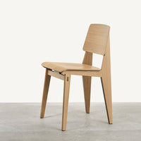 Light natural wood chair with a sleek, minimal design and clean lines, set against a neutral background.