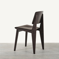 Dark wood chair with a minimalist design, featuring clean lines and a smooth finish against a light background.