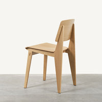 Natural wood chair with a light oak finish and minimalist design, featuring clean lines and a smooth texture.