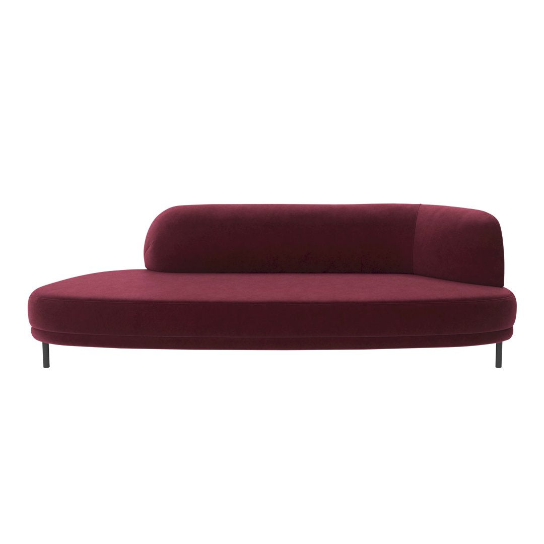 Burgundy velvet curved sofa with a smooth, modern design and minimalistic black legs. Perfect for contemporary interiors.