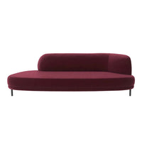 Burgundy velvet curved sofa with a smooth, modern design and minimalistic black legs. Perfect for contemporary interiors.