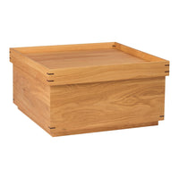 Natural wooden storage box with a smooth, light oak finish and a simple, elegant design.