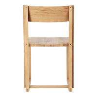 Natural oak wood chair with a smooth finish, showcasing a minimalist design and light wood tones.