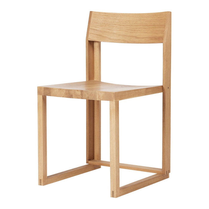 Natural wood chair with a sleek, minimalist design in light oak finish, showcasing smooth, clean lines and textures.