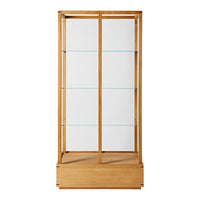 Wooden display cabinet with a natural finish, featuring clear glass shelves and a smooth, minimalist design.