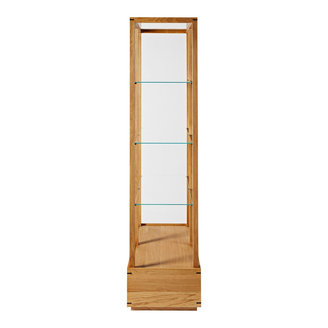 Tall wooden display cabinet with natural oak finish and clear glass shelves. Simple, modern design for any decor.