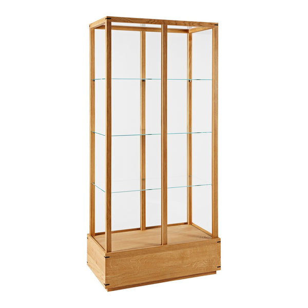 Natural wood display cabinet with clear glass shelves, showcasing a minimalist design in light oak tones.