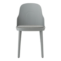 Gray chair with smooth plastic back and light gray upholstered seat. Minimalist design suits modern decor.